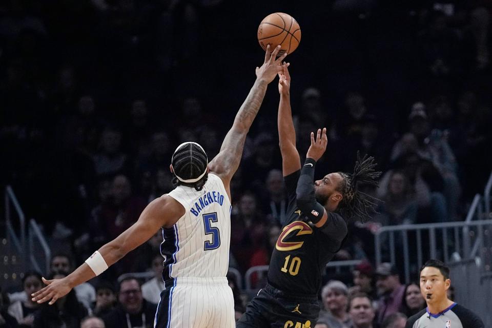 Cleveland Cavaliers guard Darius Garland (10) shoots in front of Orlando Magic forward Paolo Banchero (5) during the first half of an NBA basketball game Wednesday, Dec. 6, 2023, in Cleveland. (AP Photo/Sue Ogrocki)
