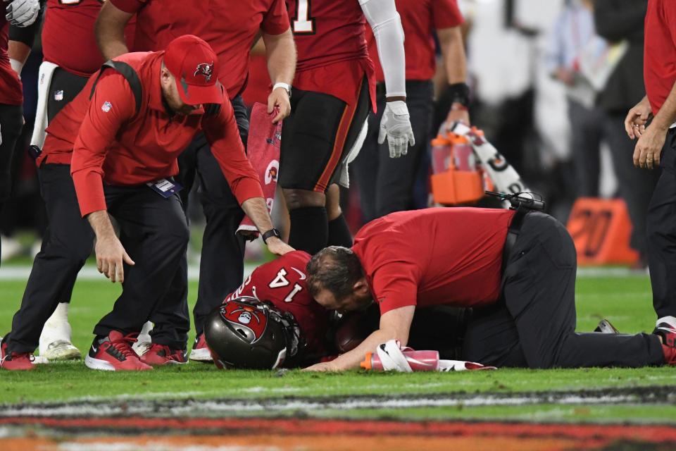 Trainers help Tampa Bay Buccaneers wide receiver Chris Godwin after he was shaken up during the first half against the New Orleans Saints.