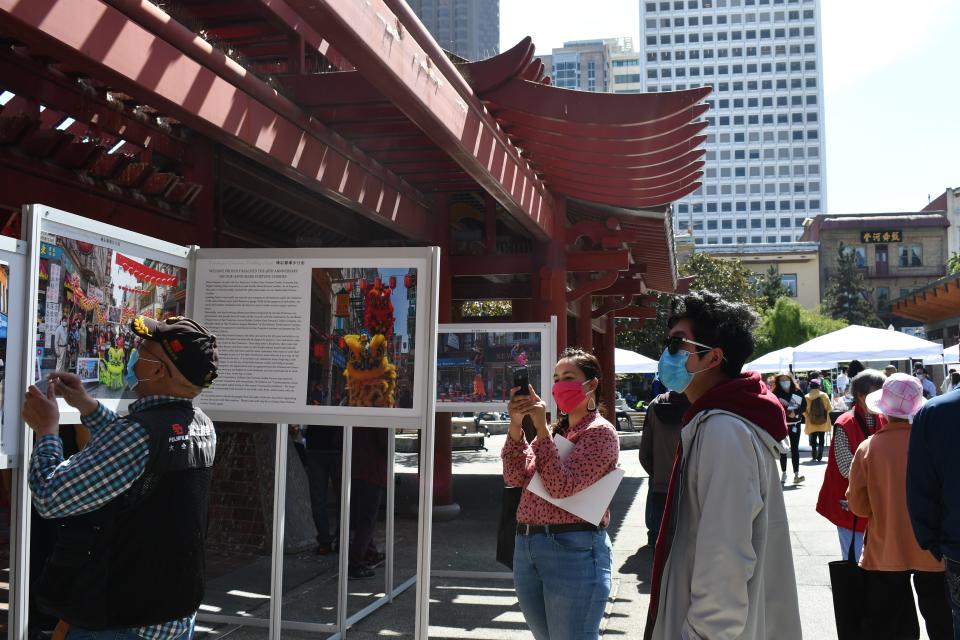 Sarah Souza snaps a photo of a display promoting completion of the 2020 Census in Portsmouth Square in San Francisco's Chinatown.