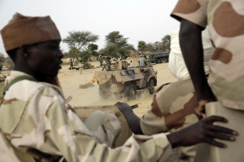 Chadian soldiers escorting a group of journalists ride on trucks and pickups in the Nigerian city of Damasak, Nigeria, Wednesday March 18, 2015. (AP Photo/Jerome Delay)