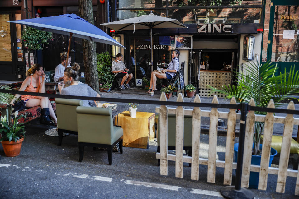 Customers dine outside PhoBar, Monday, June 22, 2020, in New York. New York City Mayor Bill de Blasio says he is delaying the planned resumption of indoor dining at restaurants in the city out of fear it would ignite a a spike in coronavirus infections. (AP Photo/John Minchillo)