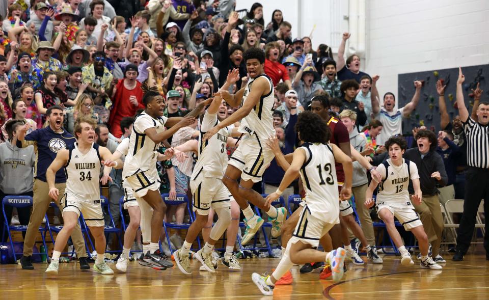 Archbishop Williams Lorenzo Jackson, center, hits the game winning three-point basket at the final buzzer versus Cardinal Spellman at Scituate High School on Wednesday, March 15, 2023.  