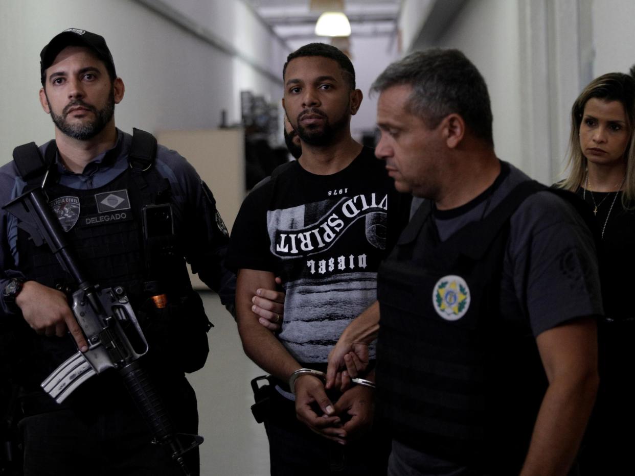 Rogerio Avelino da Silva, also known as Rogerio 157, who is accused by authorities to be the drug dealing chief of Rocinha slum, is escorted by policemen at a police station complex in Rio de Janeiro: Ricardo Moraes/Reuters