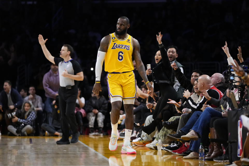 Los Angeles Lakers' LeBron James (6) and fans celebrate a three-point basket by James during the second half of an NBA basketball game against the Houston Rockets Monday, Jan. 16, 2023, in Los Angeles. The Lakers won 140-132. (AP Photo/Jae C. Hong)