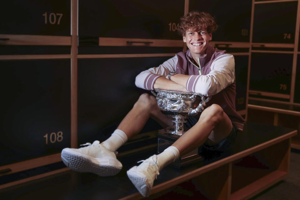 Jannik Sinner of Italy poses with the Norman Brookes Challenge Cup, Monday Jan. 29, in the locker room after defeating Daniil Medvedev of Russia in the men's singles final at the Australian Open tennis championships at Melbourne Park, Melbourne, Australia, Sunday, Jan. 28, 2024. (Fiona Hamilton/Tennis Australia via AP)