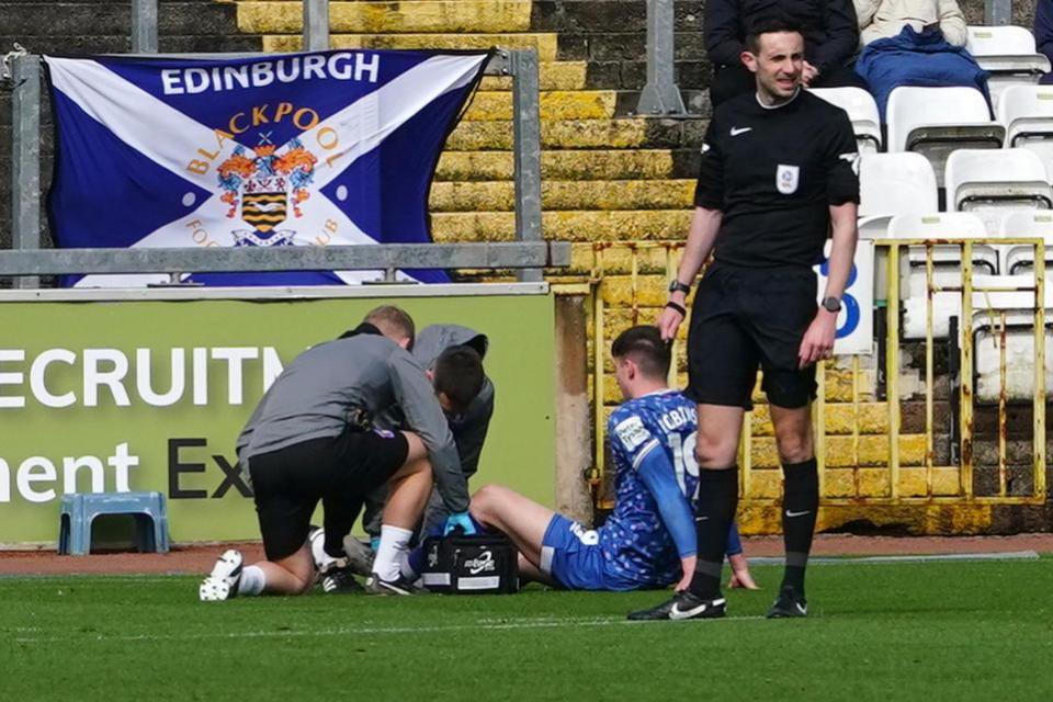 News and Star: Jack Robinson receives treatment after suffering an ankle injury against Blackpool