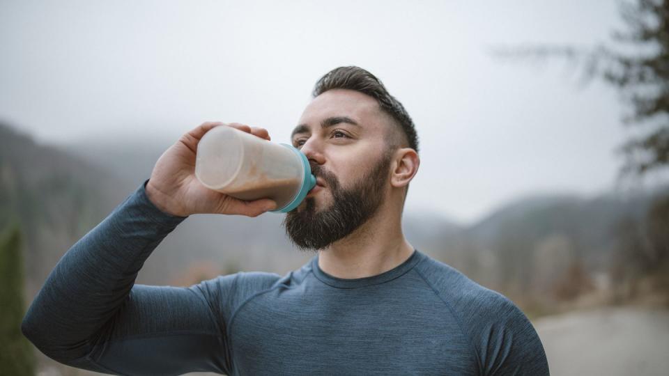 athlete drinking protein after outdoor workout