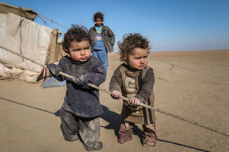 FILE PHOTO: Internally displaced Syrian children who fled Raqqa city stand near their tent in Ras al-Ain province, Syria January 22, 2017. REUTERS/Rodi Said/File Photo