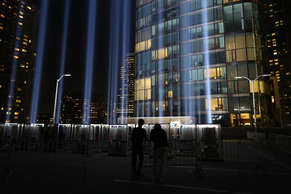 <p>Volunteers watch the beam of light from the Tribute in Light rise above the New York City skyline on Sept. 5, 2018. (Photo: Gordon Donovan/Yahoo News) </p>