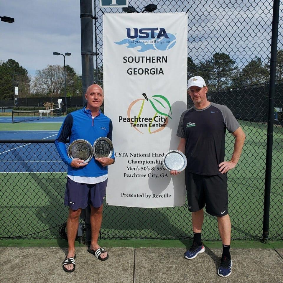 Will Calhoun, left, and Jay Harris with some of the hardware they've earned in becoming the nation's No. 1 50-and-over doubles team.