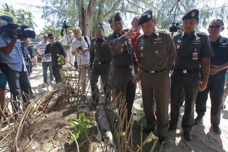 Chief of Royal Thai Police Somyot Pumphanmuang (3rd R) and Royal Thai Police advisor Jarumporn Suramanee (4th R) look on near the spot where bodies of two killed British tourists were found, on the island of Koh Tao September 20, 2014. REUTERS/Chaiwat Subprasom