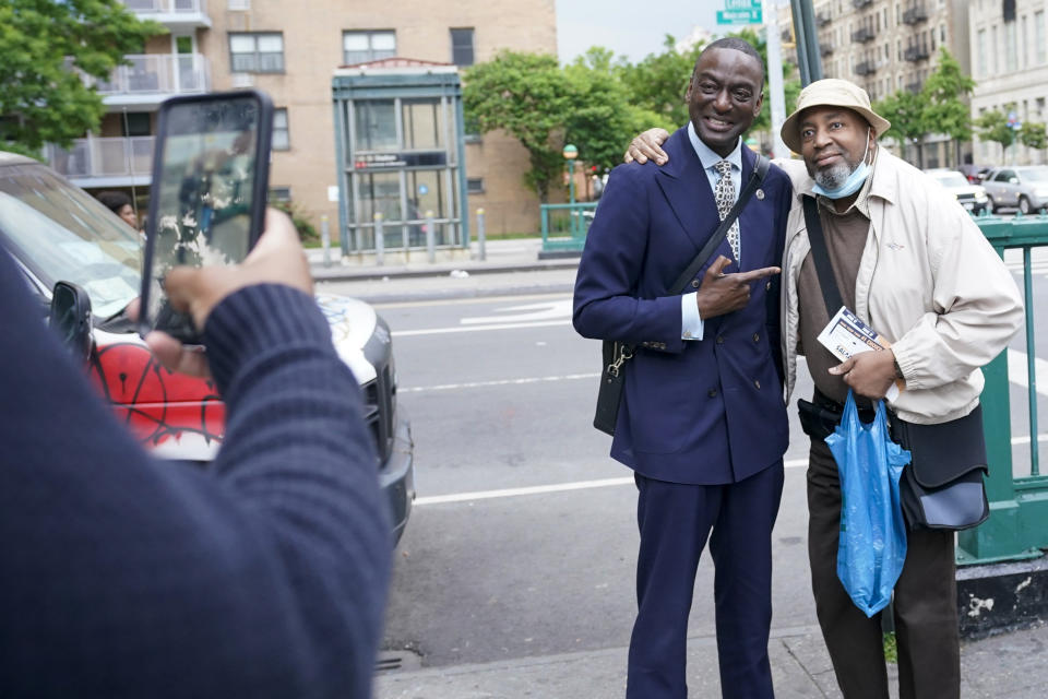 New York City Council candidate Yusef Salaam, center, takes a photo with a Harlem resident while canvasing in the neighborhood, Wednesday, May 24, 2023, in New York. Salaam is one of three candidates in a competitive June 27 Democratic primary. With early voting already begun, he faces two seasoned political veterans: New York Assembly members Al Taylor, 65, and Inez Dickens, 73, who previously represented Harlem on the City Council. (AP Photo/Mary Altaffer)