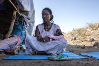 Terhas Tsfa, 25, who gave birth on a street as she fled the conflict in Ethiopia's Tigray region, holds her baby at Um Rakuba refugee camp in Qadarif, eastern Sudan, Monday, Nov. 23, 2020. Tens of thousands of people have fled a conflict in Ethiopia for Sudan, sometimes so quickly they had to leave family behind. There is not enough to feed them in the remote area of southern Sudan that they rushed to. (AP Photo/Nariman El-Mofty)