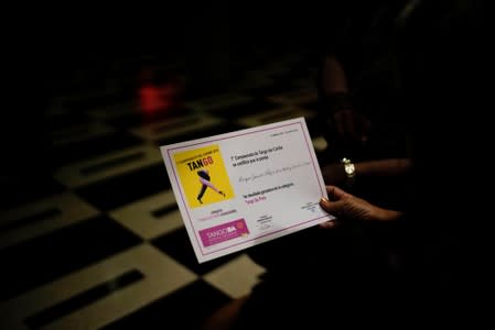 A woman holds a winning certificate of the Caribbean qualifying round for the Tango World Championship in Buenos Aires, in Havana