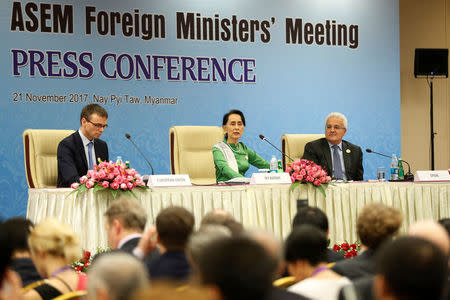 Myanmar's State Counselor Aung San Suu Kyi speaks to the media during a news conference with Estonia's Foreign Minister Sven Mikser (L) and Spain's Secretary of State Ministry of Foreign Affairs Ildefonso Castro (R) at the Asia Europe Foreign Ministers (ASEM) in Naypyitaw, Myanmar, November 21, 2017. REUTERS/Stringer