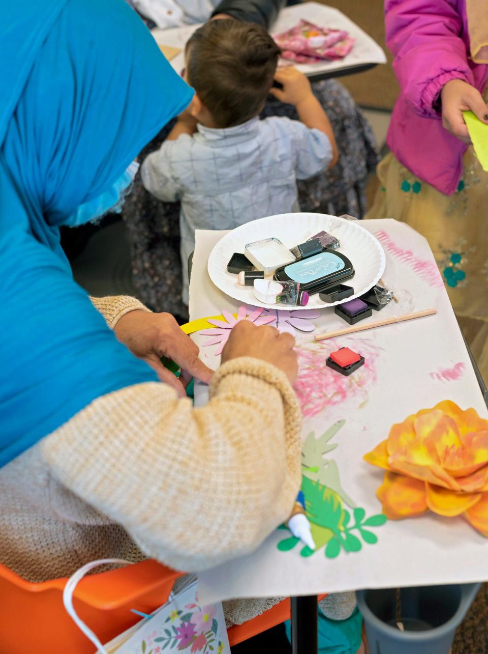 An Afghan refugee completes a Mother's Day craft project in partnership with the Stillwater Prairie Arts Center during an OSU CARES session on the Oklahoma State University campus in Stillwater.