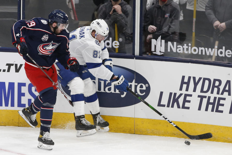 Tampa Bay Lightning's Erik Cernak, right, keeps the puck away from Columbus Blue Jackets' Liam Foudy during the second period of an NHL hockey game Thursday, Jan. 21, 2021, in Columbus, Ohio. (AP Photo/Jay LaPrete)