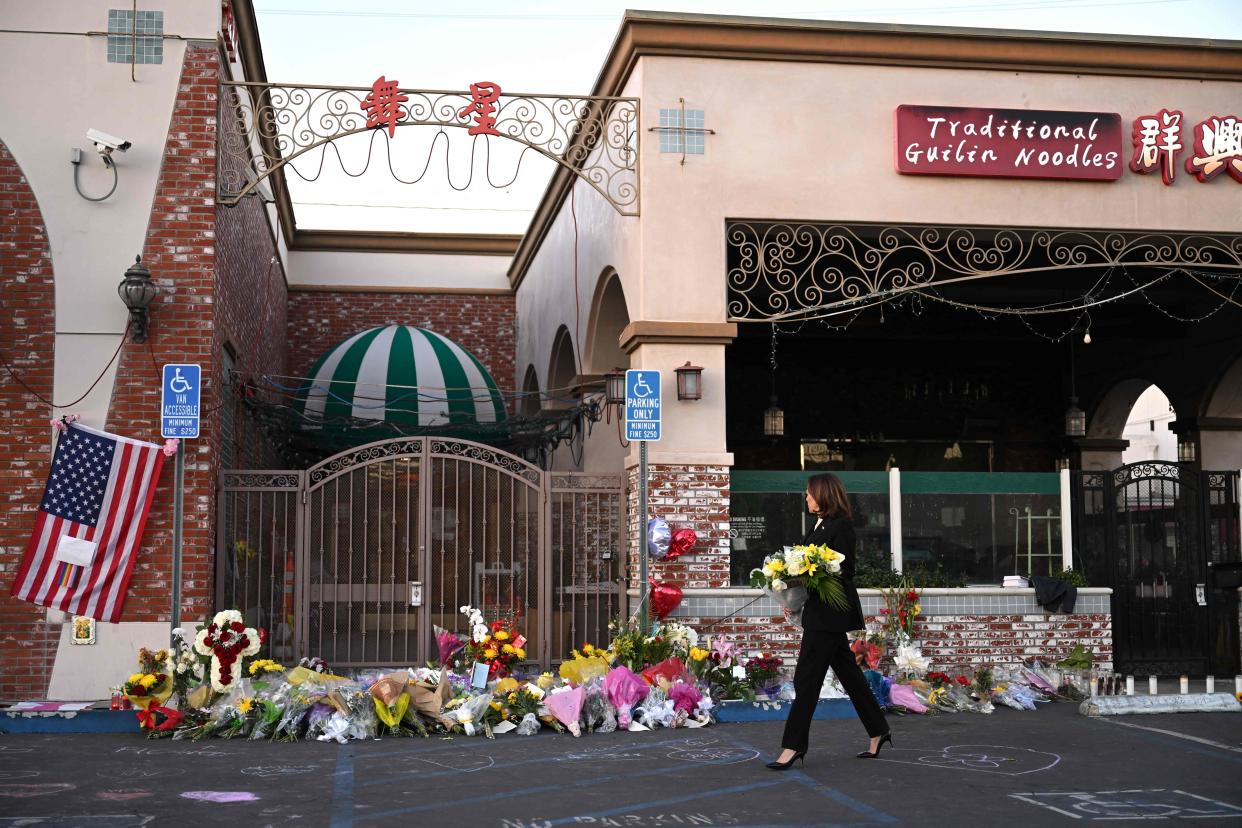 US Vice President Kamala Harris leaves flowers at a makeshift memorial at the Star Ballroom Dance Studio in Monterey Park, California. - Huu Can Tran, the 72-year-old Asian immigrant who police say killed 11 people before shooting himself, was a former regular at the dance studio.