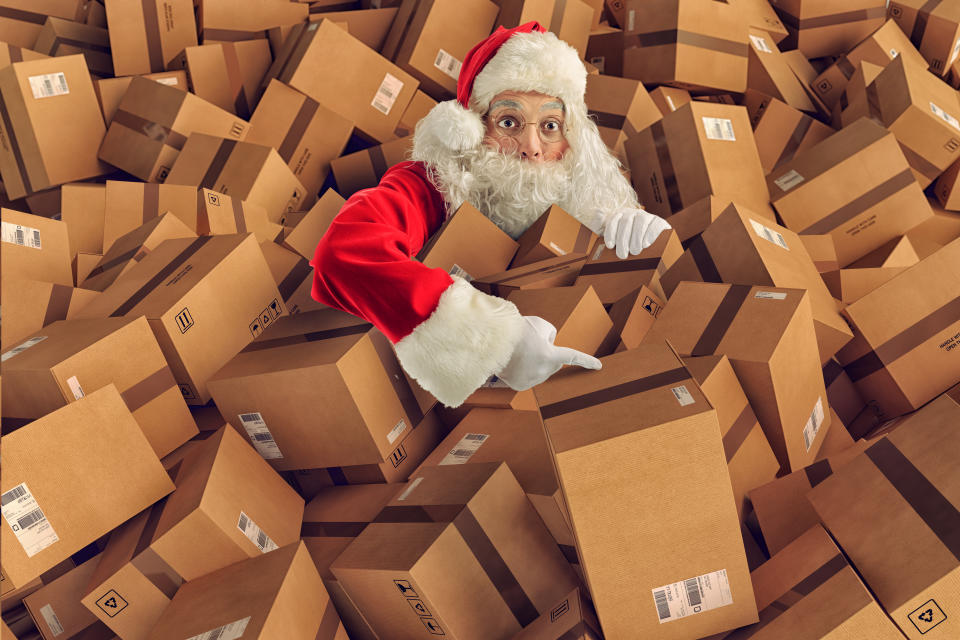 Santa in a pile of shipping boxes.