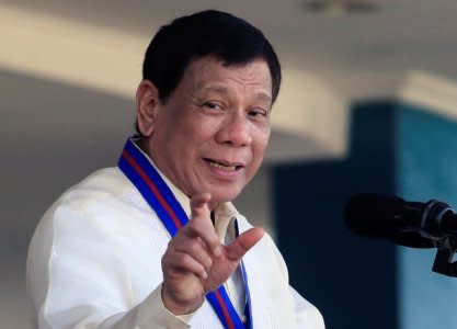 Philippine President Rodrigo Duterte gestures as he delivers his speech during the 116th Police Service Anniversary inside the Philippine National Police (PNP) headquarters in Quezon city, metro Manila, Philippines August 9, 2017.  REUTERS/Romeo Ranoco