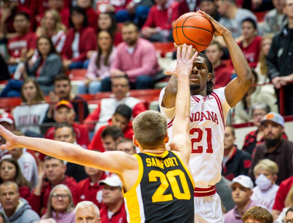 Indiana's Mackenzie Mgbako (21) shoots over Iowa's Payton Sandfort (20) during the first half of the Indiana versus Iowa men's basketball game at Simon Skjodt Assembly Hall on Tuesday, Jan. 30, 2024.