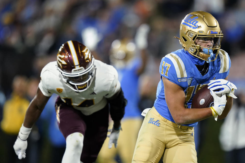 UCLA wide receiver Logan Loya, right, scores a touchdown past Arizona State defensive back Alphonso Taylor during the second half of an NCAA college football game Saturday, Nov. 11, 2023, in Pasadena, Calif. (AP Photo/Ryan Sun)