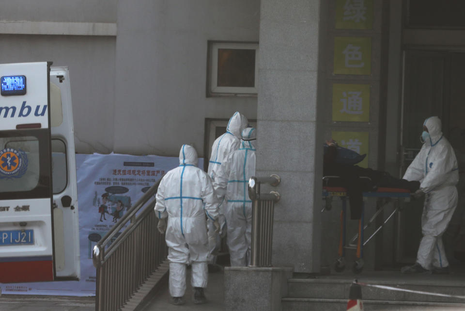 Medical staff transfer a patient from an ambulance at the Jinyintan hospital, where the patients with pneumonia caused by the new strain of coronavirus are being treated, in Wuhan, Hubei province, China January 20, 2020. REUTERS/Stringer CHINA OUT.