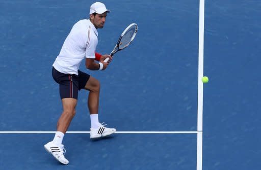 Novak Djokovic of Serbia hits a backhand against Juan Martin Del Potro of Argentina. Djokovic reached his second final in two weeks, beating Del Potro 6-3, 6-2 at the Cincinnati ATP-WTA Masters for a 15th hardcourt match win in a row