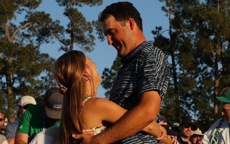 Scottie Scheffler of the U.S. celebrates with his wife Meredith Scudder after winning The Masters