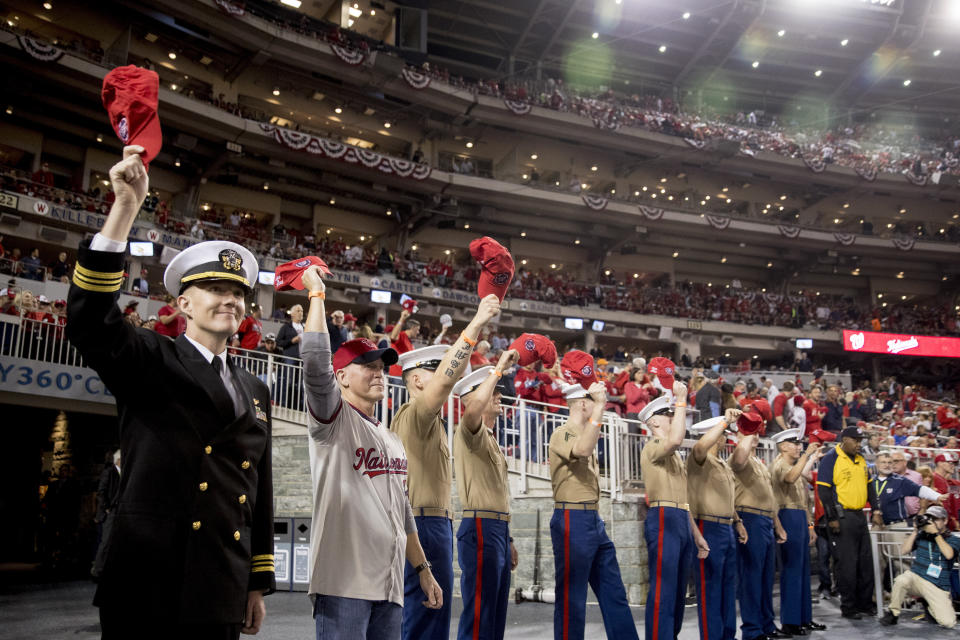 Members of the military stand during a Salute to the Military event during Game 5 of a baseball World Series game between the Houston Astros and the Washington Nationals at Nationals Park in Washington, Sunday, Oct. 27, 2019. (AP Photo/Andrew Harnik)