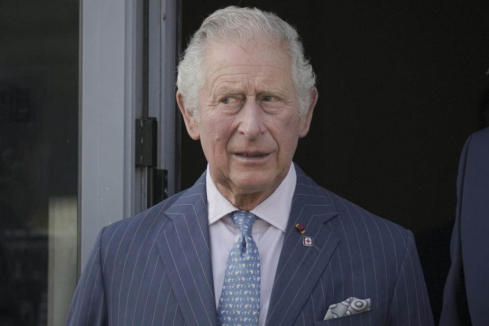 Britain's Prince Charles exits a center for refugees fleeing the war in neighboring Ukraine, at the Romexpo convention center, in Bucharest, Romania, Wednesday, May 25, 2022. (AP Photo/Vadim Ghirda)