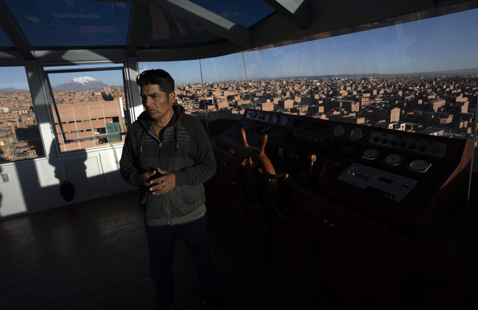 El arquitecto Freddy Mamami se encuentra en la azotea de su atracción arquitectónica, "Crucero de los Andes", decorado con símbolos de las culturas Tiwanakota e Inca, se eleva sobre El Alto, Bolivia, el viernes 8 de septiembre de 2023. Mamami es el creador del edificio. Conocido popularmente como cholet, término que combina las palabras cholo y chalet. (Foto AP/Juan Karita)