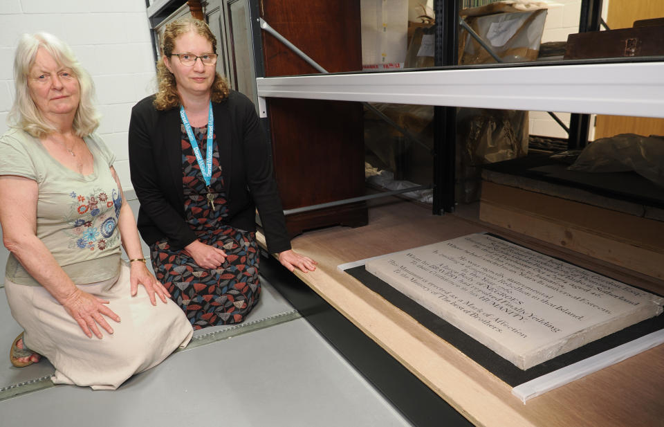 Church warden Val Potter, left, with Elizabeth Selby, acting director of Dorset County Museum as the plaque is moved into storage (Geoff Moore, Dorset Media Services/Diocese of Salisbury/PA)