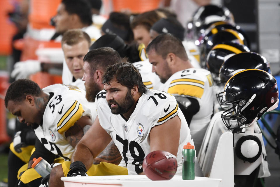 Alejandro Villanueva in a No. 78 jersey sits with teammates on the bench. 