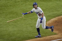 Los Angeles Dodgers' Cody Bellinger watches his two-run home run against the Tampa Bay Rays during the fourth inning in Game 1 of the baseball World Series Tuesday, Oct. 20, 2020, in Arlington, Texas. (AP Photo/Sue Ogrocki)