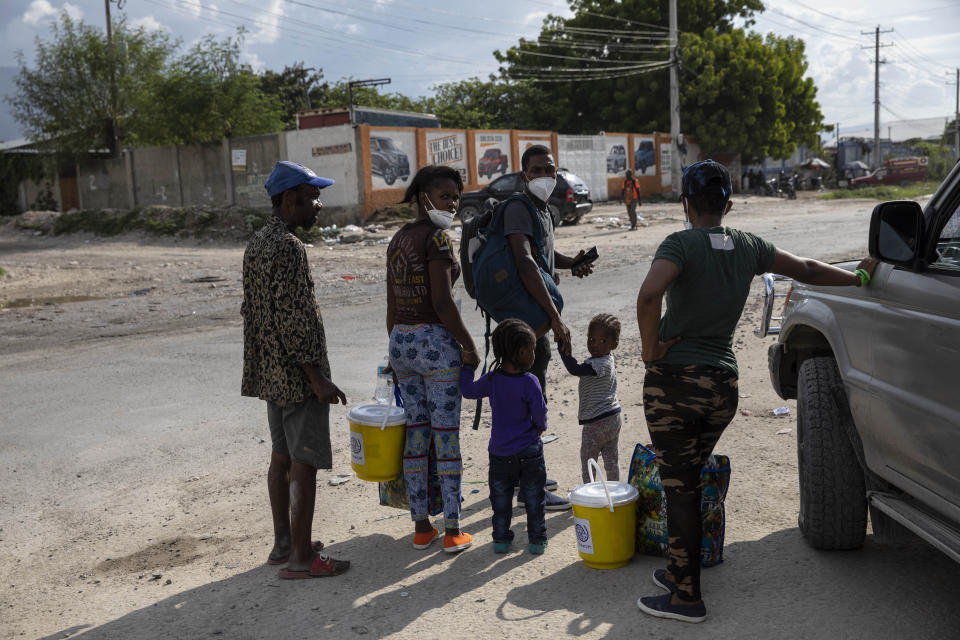 Haitian migrants deported from the US leave the Toussaint Louverture International Airport in Port-au-Prince, Haiti, Sunday, Sept. 19, 2021. Thousands of Haitian migrants have been arriving to Del Rio, Texas, to ask for asylum in the U.S., as authorities begin to deported them to back to Haiti. (AP Photo/Rodrigo Abd)