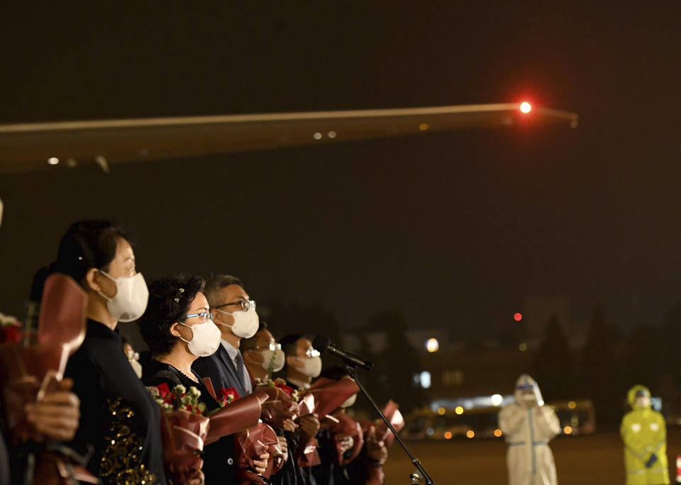 In this photo released by China's Xinhua News Agency, staff members from the Chinese Consulate in Houston, USA, arrive at an airport in Beijing, Monday, Aug. 17, 2020. A charter flight carrying employees of the consulate, which was ordered closed by the U.S. government in July amid escalating diplomatic tensions, arrived in Beijing on Monday night. (Yue Yuewei/Xinhua via AP)