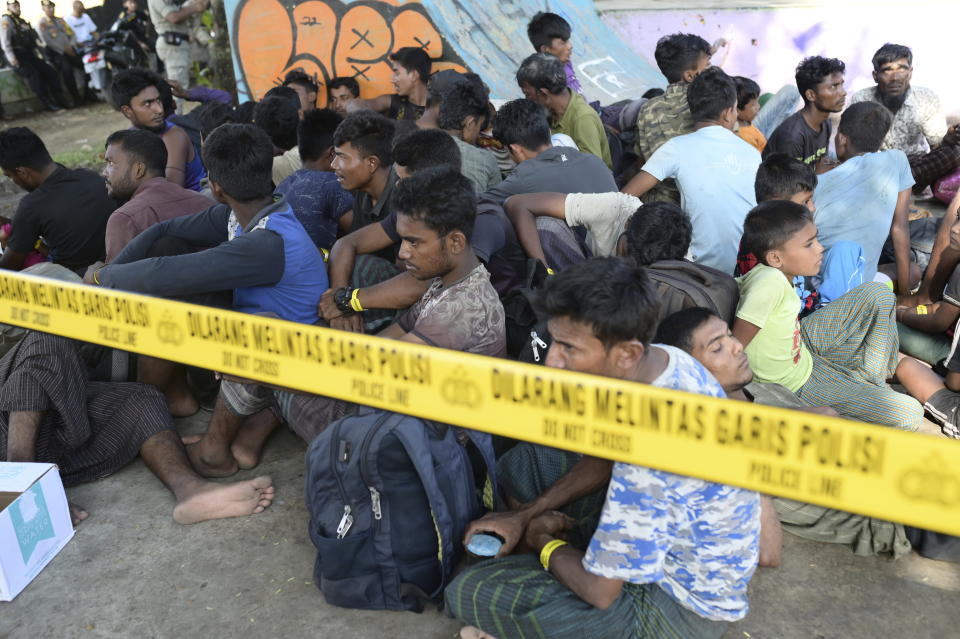 Rohingya refugees sit at a park near the governor's office in Banda Aceh, Indonesia, Monday, Dec. 11, 2023. Two boats carrying hundreds of Rohingya Muslims, including emaciated women and children, arrived on Sunday at Indonesia's northernmost province of Aceh where they faced rejection from local communities who are protesting against the increasing numbers of refugees that have entered the region over the past few weeks. (AP Photo/Reza Saifullah)