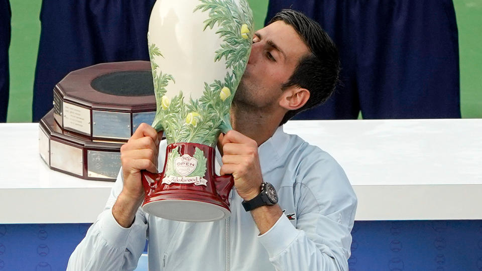 Novak Djokovic kisses the trophy after defeating Roger Federer. (Photo by Adam Lacy/Icon Sportswire via Getty Images)