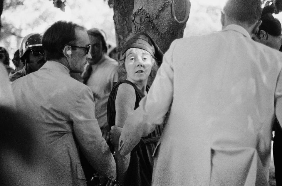 FILE- In this Sept. 5, 1975 file photo, U.S. Secret Service agents put handcuffs on Lynette "Squeaky" Fromme after she pointed at President Gerald Ford, in Sacramento, Calif. Nearly 40 years after the former Manson family member pointed a gun at President Gerald Ford, the audiotape from her pretrial psychiatric examination has been made public. (AP Photo/File)