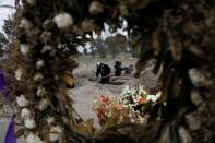 Cemetery workers dig new graves at a designated area for people who died of the coronavirus disease (COVID-19) in Mexico City