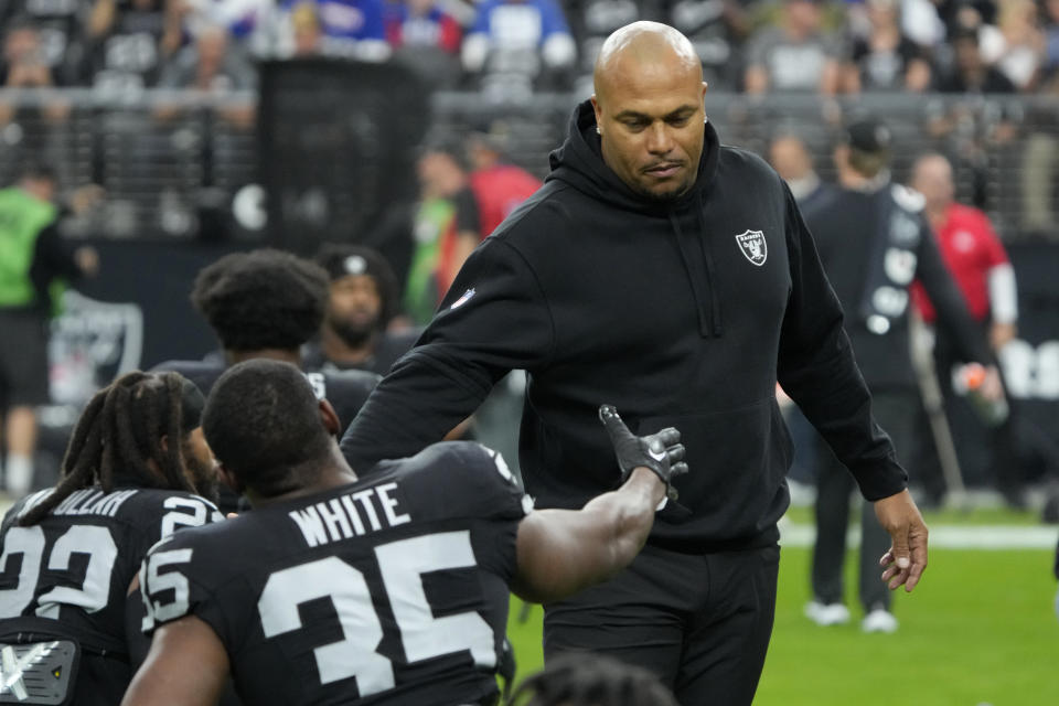 Las Vegas Raiders interim head coach Antonio Pierce meets with players before an NFL football game against the New York Giants, Sunday, Nov. 5, 2023, in Las Vegas. (AP Photo/Rick Scuteri)