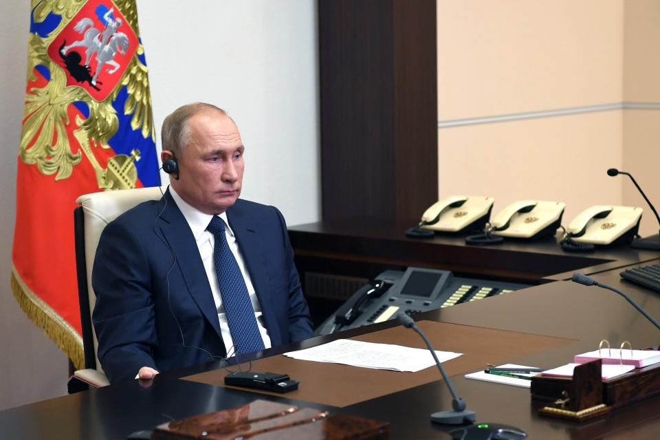 Russian President Vladimir Putin, listens to Syrian President Bashar Assad, on a screen, during their talks via video conference at the Novo-Ogaryovo residence outside Moscow, Russia, Monday, Nov. 9, 2020. (Alexei Nikolsky, Sputnik, Kremlin Pool Photo via AP)