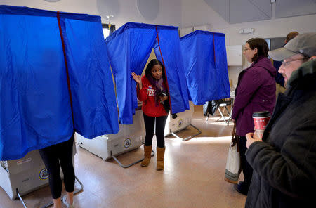 FILE PHOTO: A voter leaves the polling booth during the U.S. presidential election in Philadelphia, Pennsylvania, U.S. November 8, 2016. REUTERS/Charles Mostoller/File Photo