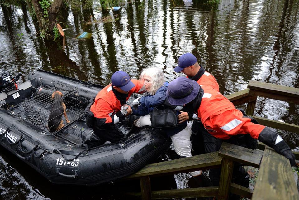 Members of Coast Guard rescue an elderly woman and her husband along with their pets in Brunswick County, N.C.