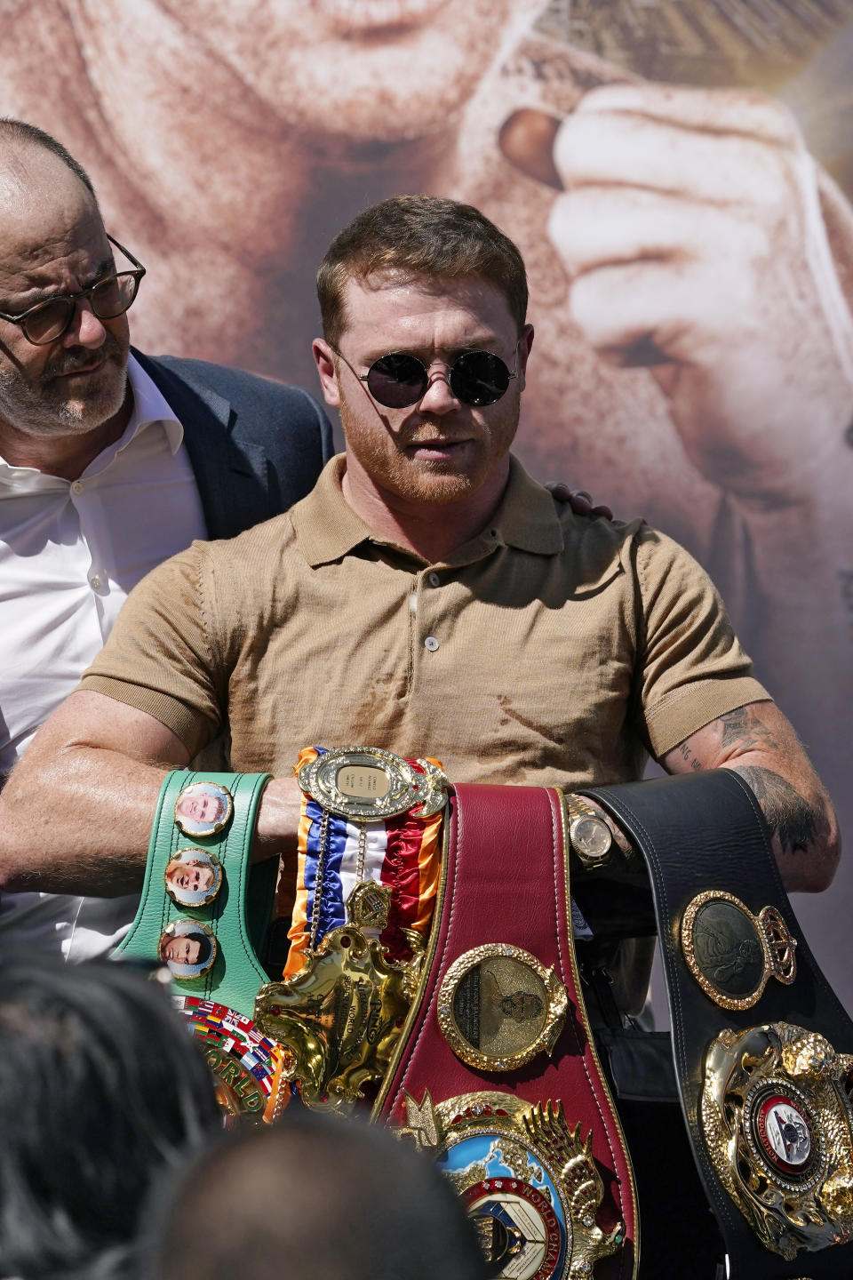 Unified WBC/WBO/WBA super middleweight champion Canelo Alvarez poses with his belts during a news conference Tuesday, Sept. 21, 2021, in Beverly Hills, Calif. to announce his 168-pound title bout against undefeated IBF Super Middleweight Champion Caleb Plant. The fight is scheduled for Saturday, Nov. 6 in Las Vegas. (AP Photo/Mark J. Terrill)