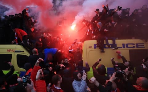 Liverpool fans fashion perches atop Merseyside police vans - Credit: Peter Byrne/PA