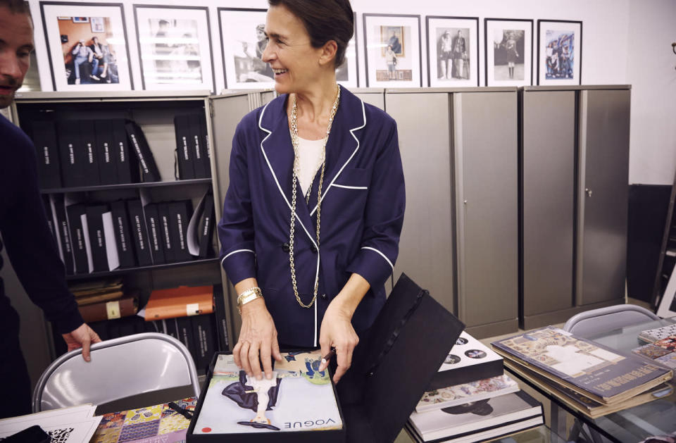 The designer checks out an archival issue of Vogue for inspiration.