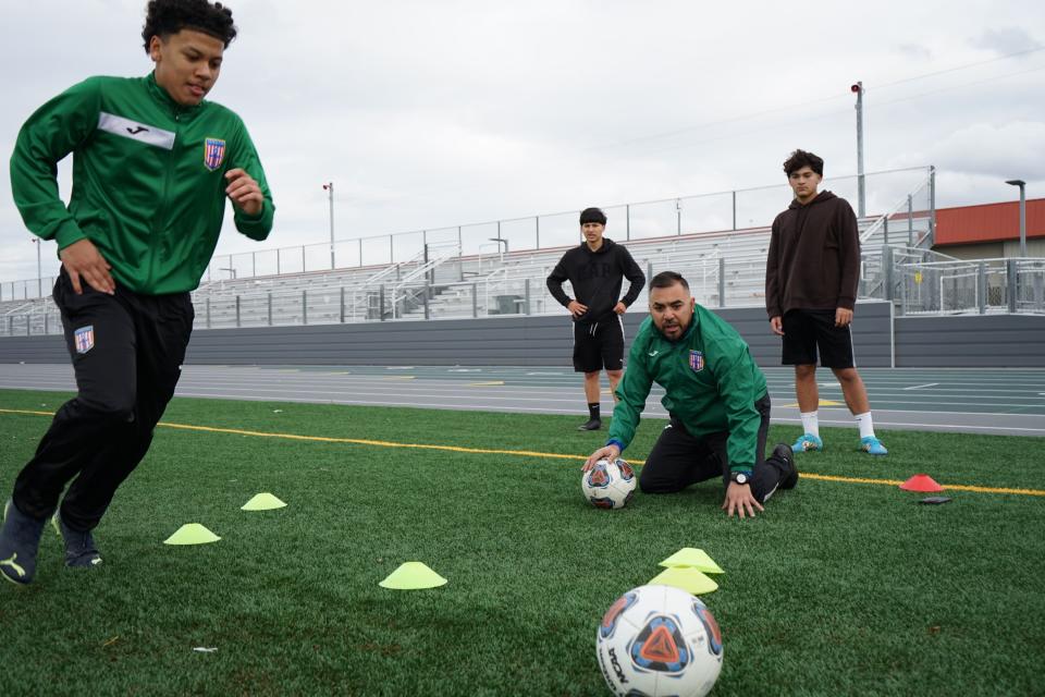 Franklin's Angelo Vieyra (left) performs a dribbling soccer drill alongside Chris Hernandez (center), Daniel Guerra and Aaron Chavez as they prepare for their youth soccer club trials in Cincinnati, Ohio.