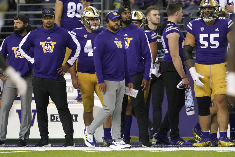 Washington coach Jimmy Lake, center, stands on the sideline during the second half of the team's NCAA college football game against UCLA, Saturday, Oct. 16, 2021, in Seattle. UCLA won 24-17. (AP Photo/Ted S. Warren)